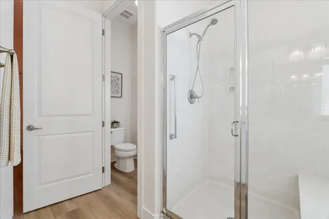 a bathroom with a granite countertop shower toilet and a sink