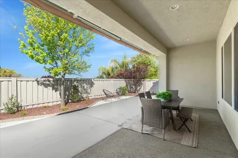 a view of a porch with furniture and garden