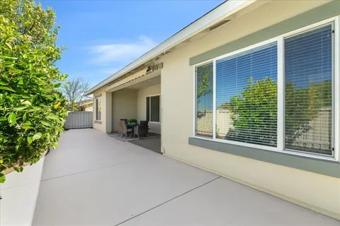 a view of a house with backyard and sitting area