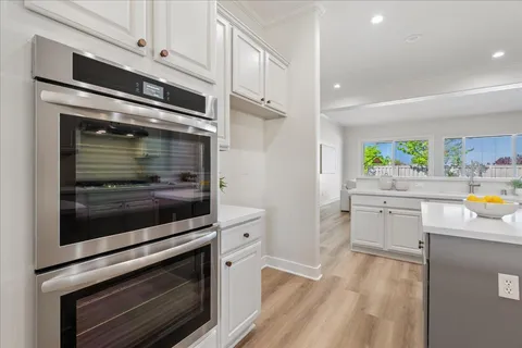 a kitchen with stainless steel appliances white cabinets and a stove