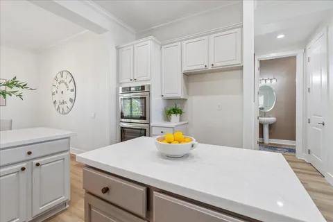 a kitchen with a sink and a stove top oven