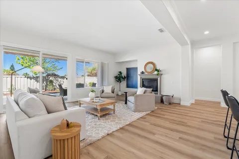 a living room with fireplace furniture and a wooden floor