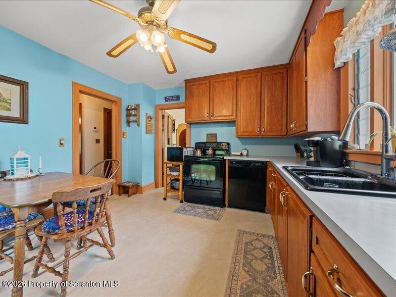 71 Pleasant Avenue Thompson, PA 18465 - Photo 12 of 37 a kitchen with stainless steel appliances a stove a sink a refrigerator cabinets and dining table