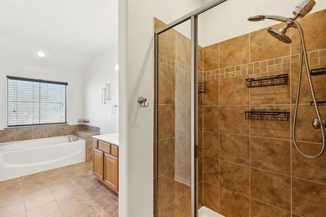 a bathroom with a tub sink and mirror
