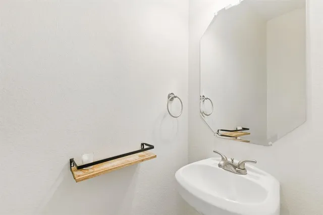 a kitchen with granite countertop a sink a stove and refrigerator