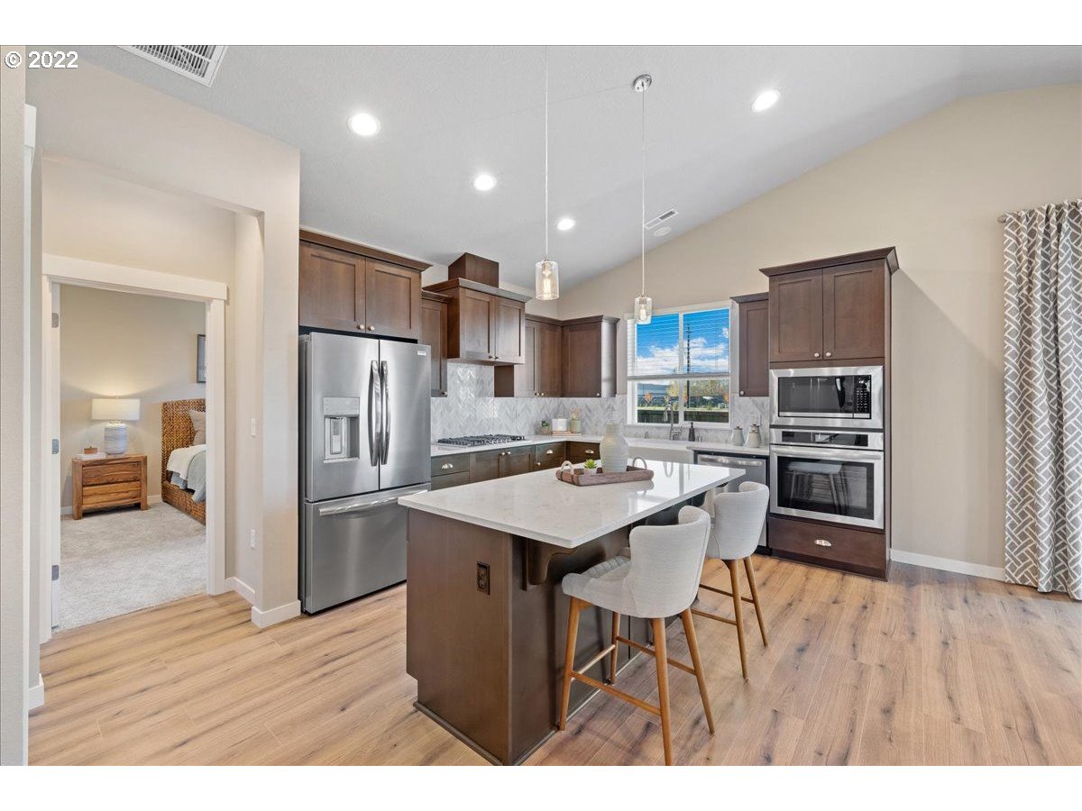 517 North 88th Drive, Unit LT 22 Ridgefield, WA 98642 - Photo 8 of 19 a kitchen with kitchen island a sink stove and refrigerator