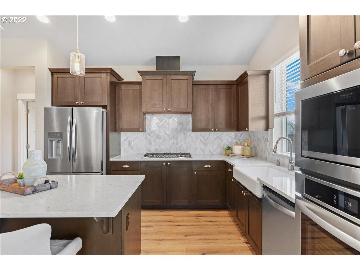517 North 88th Drive, Unit LT 22 Ridgefield, WA 98642 - Photo 9 of 19 a kitchen with kitchen island a sink counter top space cabinets and stainless steel appliances
