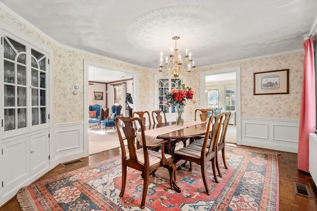 a view of a dining room with furniture and chandelier