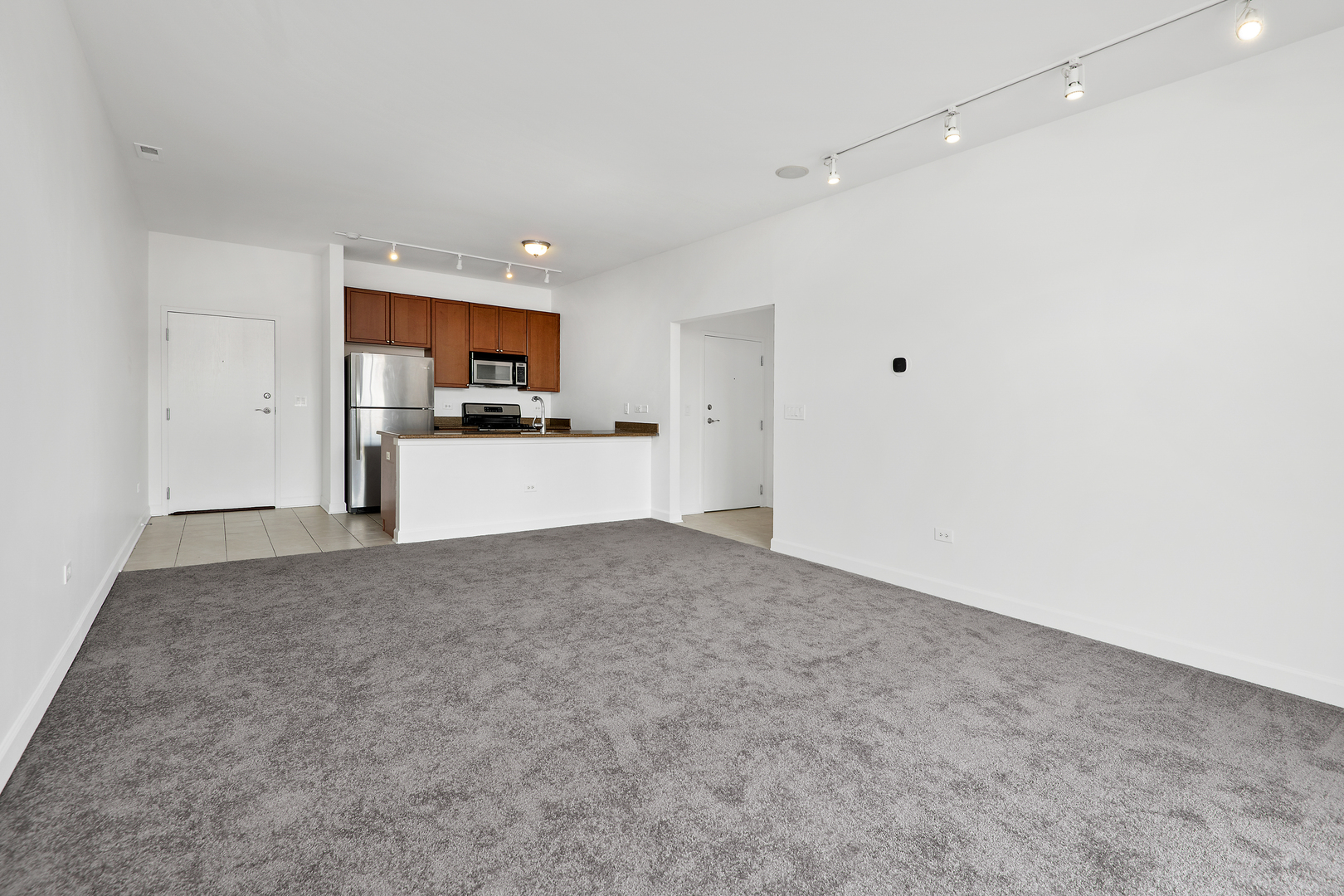 758 West 14th Street, Unit 303 Chicago, IL 60607 - Photo 3 of 9 a view of a kitchen with a sink and a refrigerator