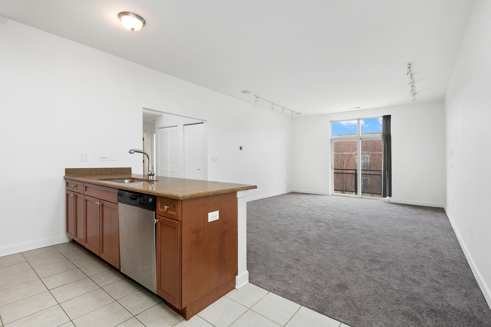 758 West 14th Street, Unit 303 Chicago, IL 60607 - Photo 4 of 9 a kitchen with stainless steel appliances granite countertop a sink and a stove
