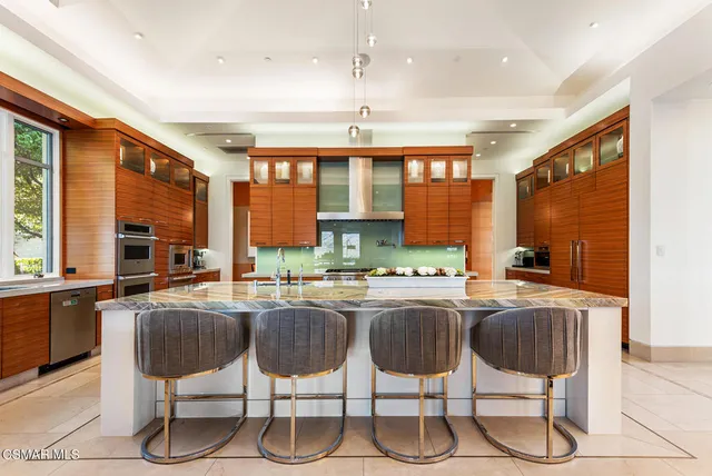 a kitchen with granite countertop lots of counter top space and stainless steel appliances