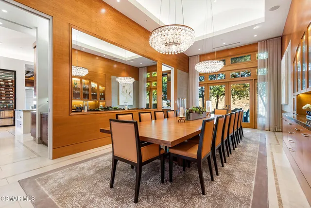 a dining room with furniture a chandelier and wooden floor