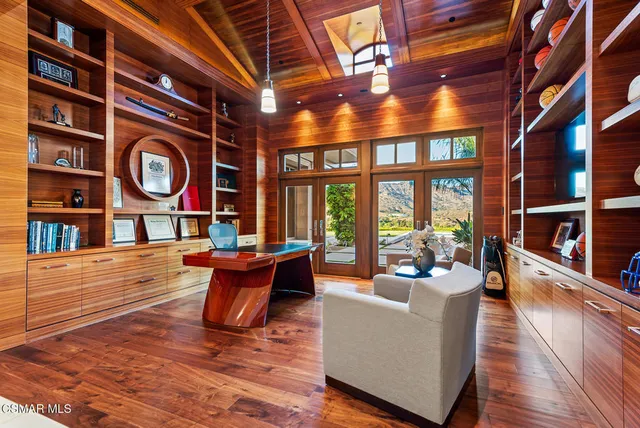a living room with fireplace furniture and a large window
