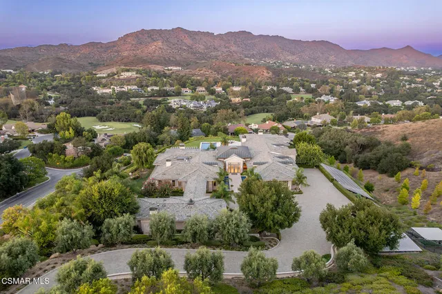 an aerial view of residential house with outdoor space and mountain view