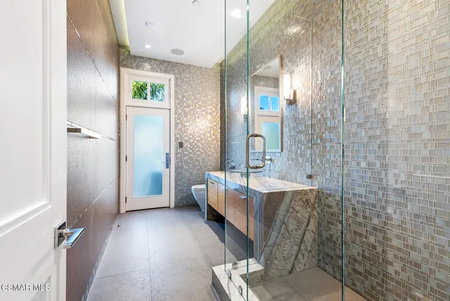 a bathroom with a tub sink and mirror