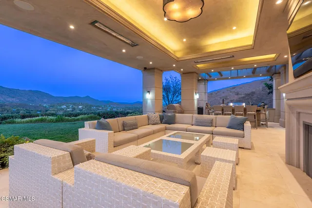a view of a patio with couches and pool
