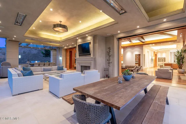 a living room with furniture a large window and a table