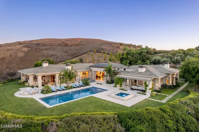 an aerial view of a house with swimming pool garden and patio