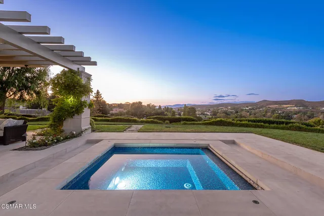 a view of swimming pool with a lounge chairs