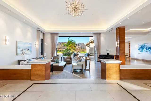 a living room with fireplace furniture and a large window