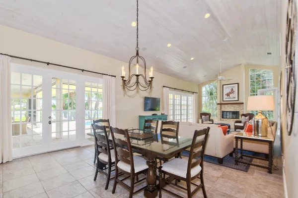 a living room with furniture a chandelier and a large window
