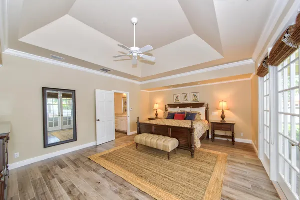 a bedroom with a bed and wooden floor