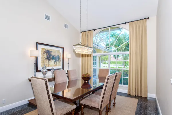 a living room with furniture a rug and a large window