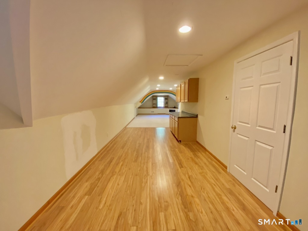 12 Carriage Hill Road Woodbridge, CT 06525 - Photo 23 of 24 a view of a room with wooden floor and staircase