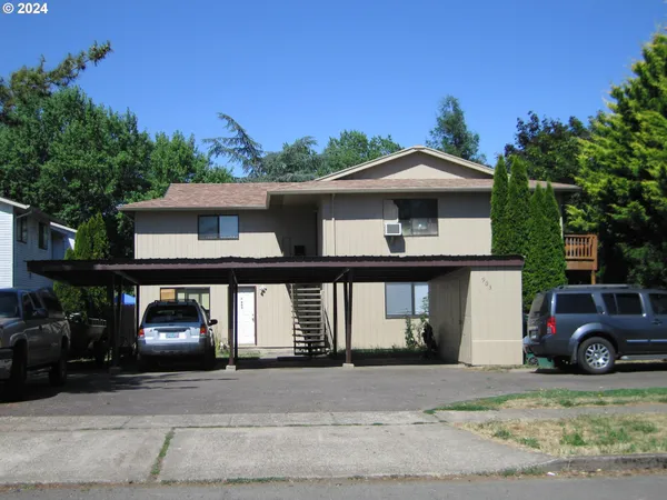 a front view of a house with car parked
