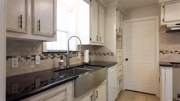 a kitchen with stainless steel appliances granite countertop a sink and cabinets