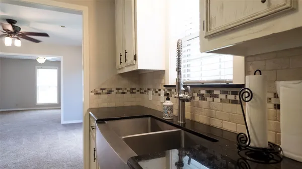 a room with a sink and cabinets