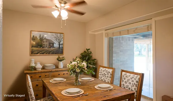 a view of a dining room with furniture wooden floor and chandelier