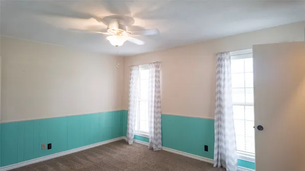 a view of a room that has a fan and window in it