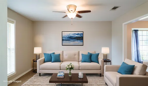 a living room with furniture a bed and a chandelier