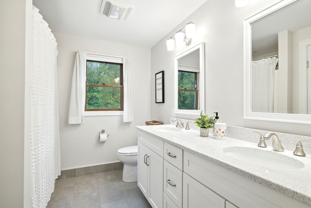 3 Pine Knoll Road Southwick, MA 01077 - Photo 33 of 42 a bathroom with a double vanity sink toilet and a mirror