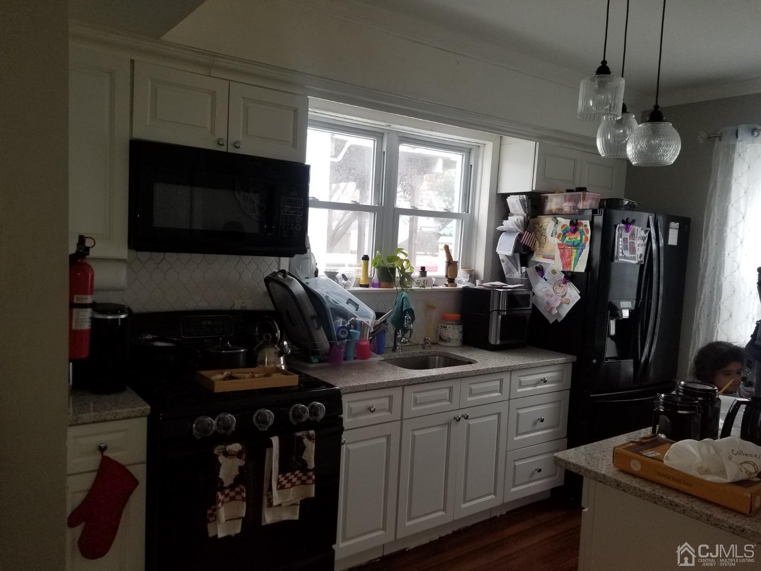 118 Rector Street Perth Amboy, NJ 08861 - Photo 1 of 12 a kitchen with a sink stove and cabinets