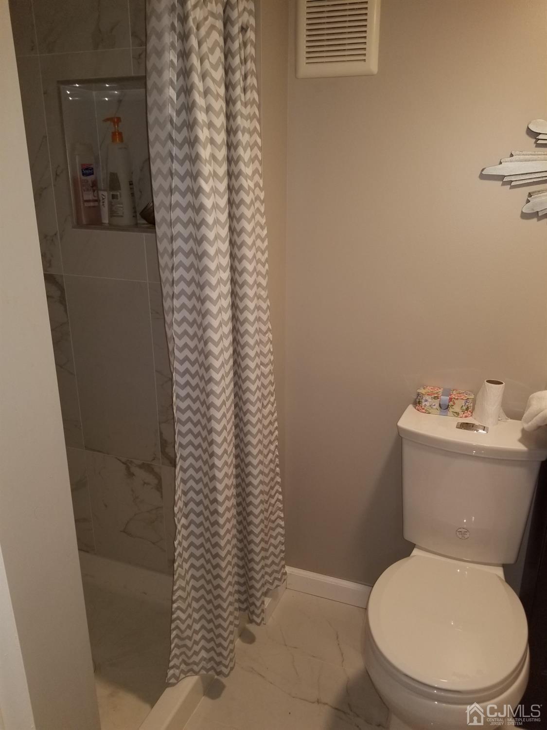 118 Rector Street Perth Amboy, NJ 08861 - Photo 6 of 12 a white toilet sitting next to a shower