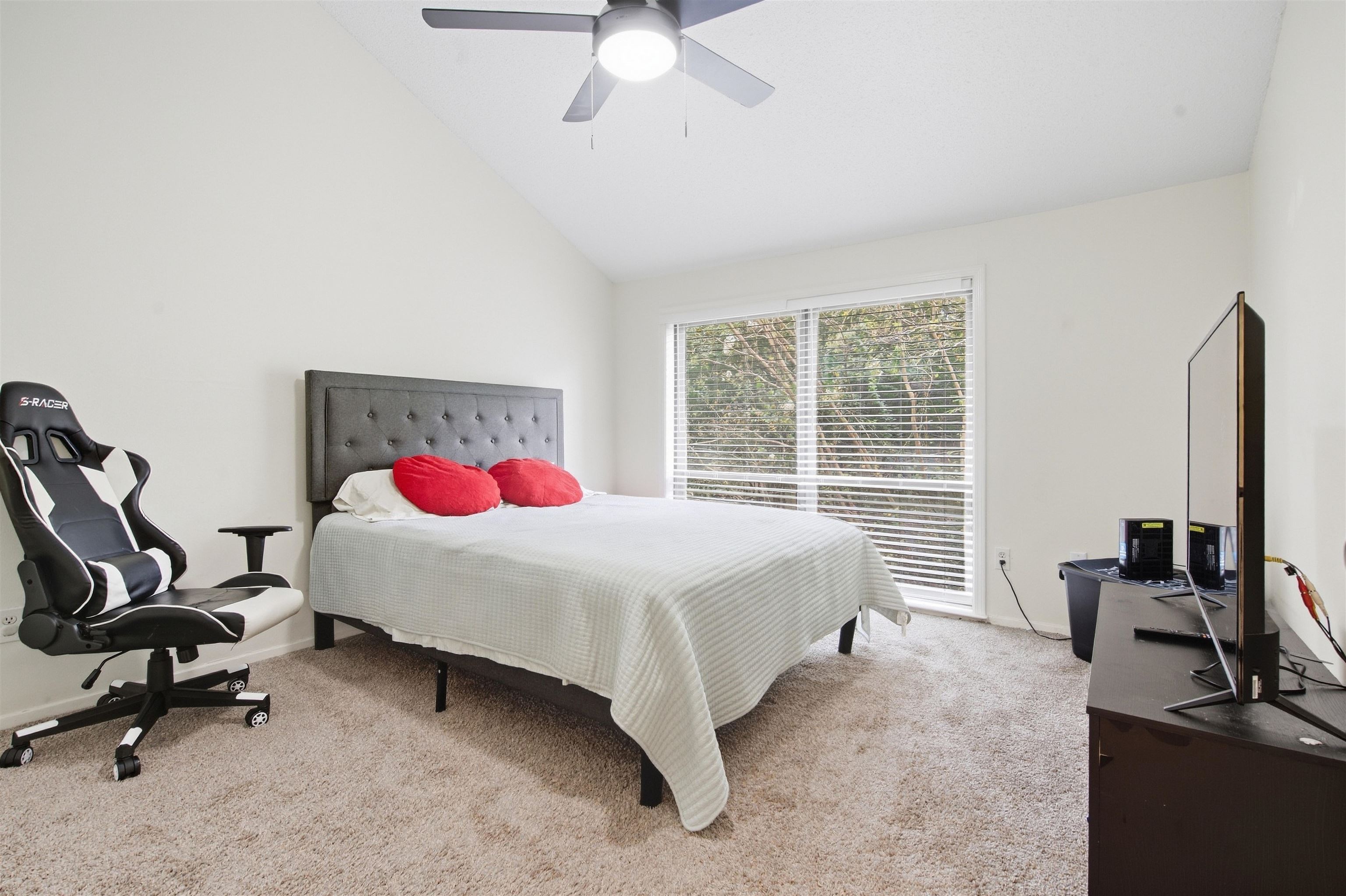 8367 Brownstone Lane, Unit 22 Cordova, TN 38016 - Photo 11 of 20 Vaulted ceiling, ceiling fan, white walls, carpeted flooring, and large window with blinds