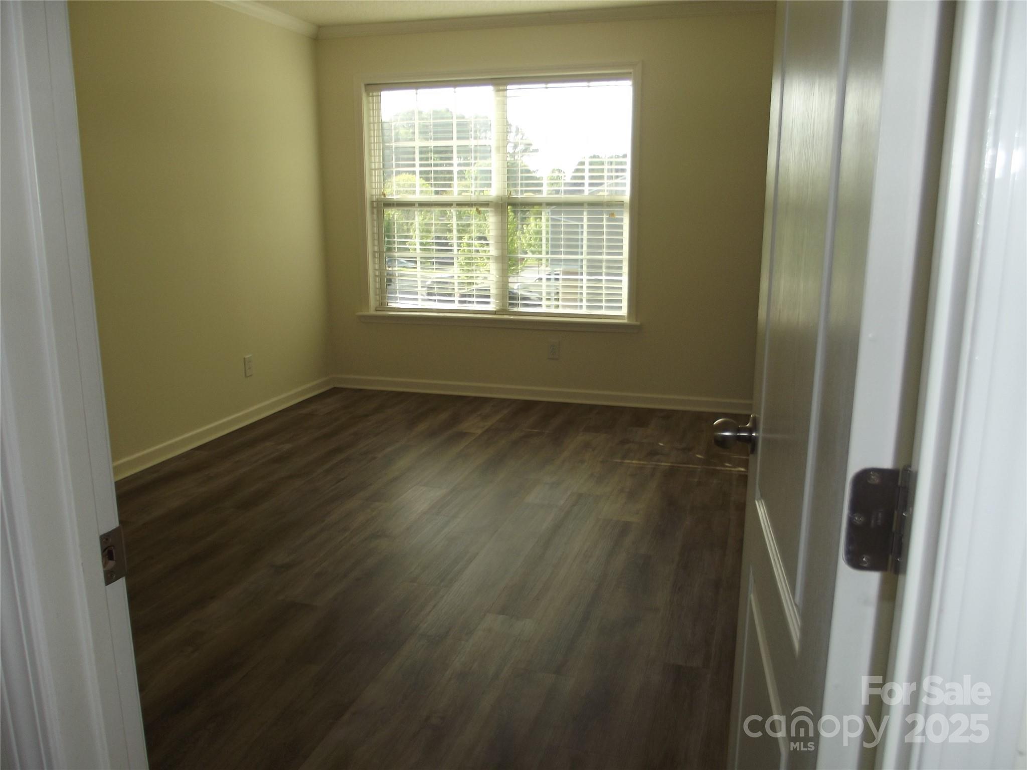 1502 Mulberry Ridge Drive, Unit 1 Newton, NC 28658 - Photo 25 of 39 a view of an empty room with wooden floor and a window