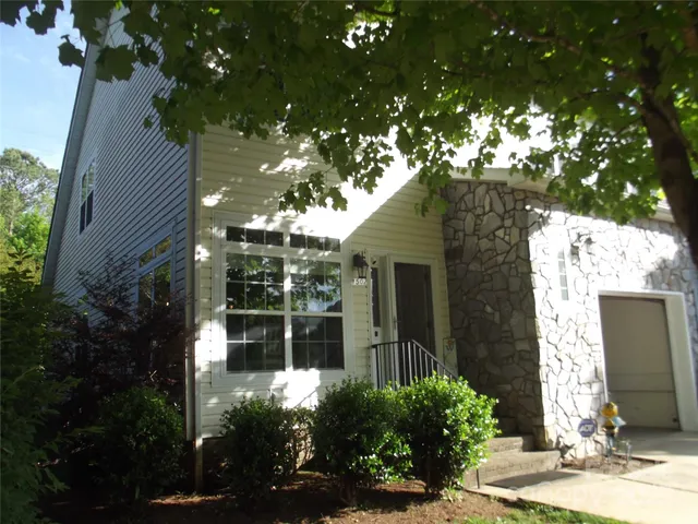 a front view of a house with a yard garage and outdoor seating