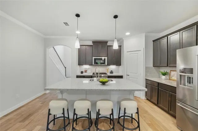 a large kitchen with a table and chairs