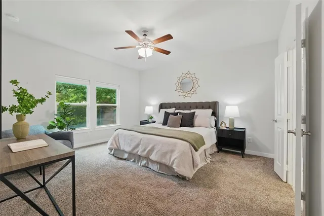 a bedroom with a large bed and a window