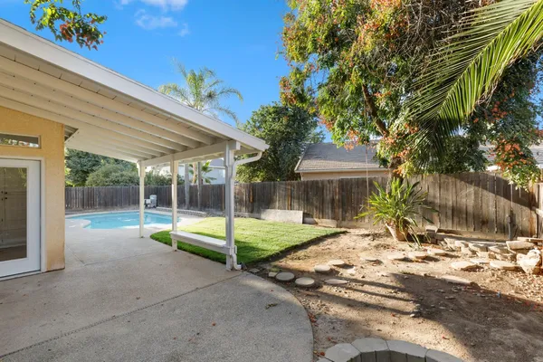a backyard of a house with table and chairs