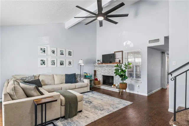 a living room with furniture flat screen tv and a fireplace