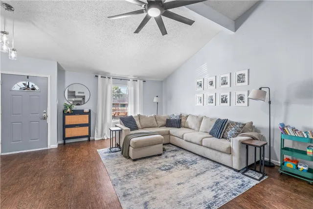 a living room with furniture and wooden floor