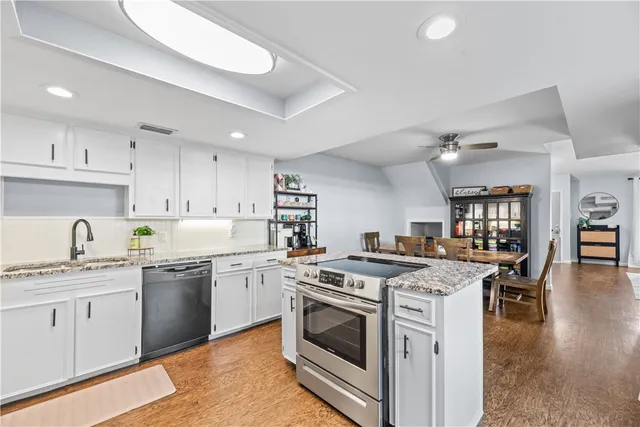 a kitchen with a stove top oven sink and cabinets