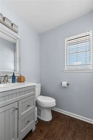 a bathroom with a toilet a sink and mirror