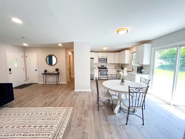 a view of a dining room with furniture and wooden floor