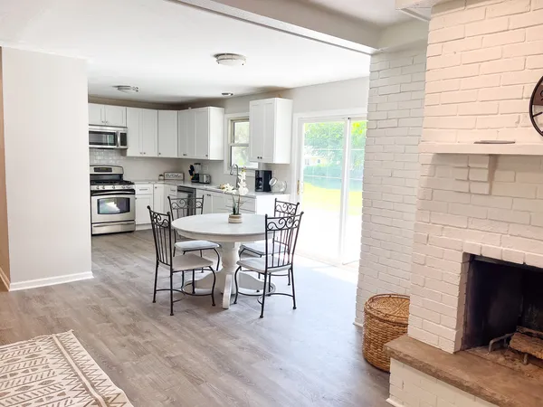 a dining room with furniture and wooden floor