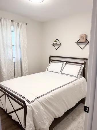 a bedroom with a bed and a table